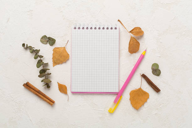 istock Autumn leaves with notebook on concrete background, top view 2148747776