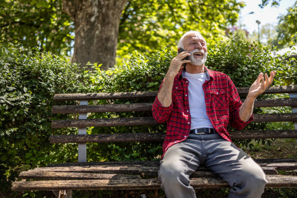 istock An elderly man is sitting on a park bench and enjoying a spring day 2148747827