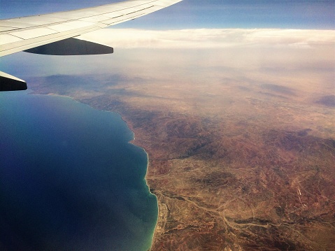 View of North African Desert and Mediterranean Sea from airplane above.