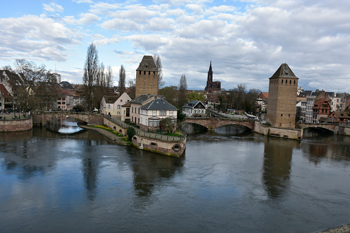 Strasbourg, France - March 16, 2024: Ponts Couverts, Strasbourg, Strasbourg River Ill Tour Boat, Building Exterior, People Walking, Standing During Springtime Scene And More
