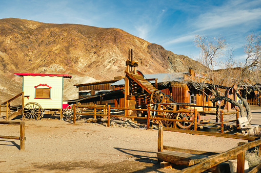 Calico, CA, USA, 2-2-2019. Wooden mining machinery and a horse drawn cart in the Wild West ghost town of Calico, San Bernardino County, California, USA