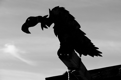 Calico, CA, USA, 2-2-2019. Monochrome silhouette of a vulture on a gallows in the Wild West ghost town of Calico, San Bernardino County, California, USA