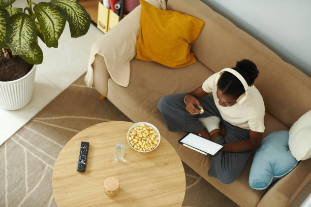 istock Black Woman Watching Show on Tablet 2148749280