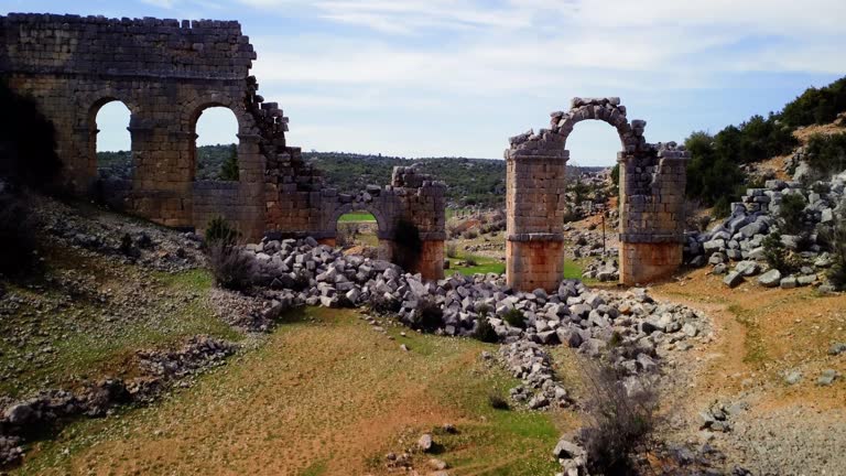 Drone video of Olba, Turkey, featuring ancient rome, gate, in ruins. Explore historic ancient rome, gate, from aerial view. Footage highlights ancient rome, gate, among ruins