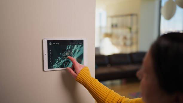 istock Close-up video of senior woman activating artificial intelligence smart home security system in smart house before leaving house 2148749740