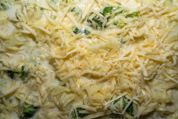 crunchy baked broccoli topped with panko breadcrumbs and parmesan cheese in a baking dish on rustic wood table, close-up, not AI generated