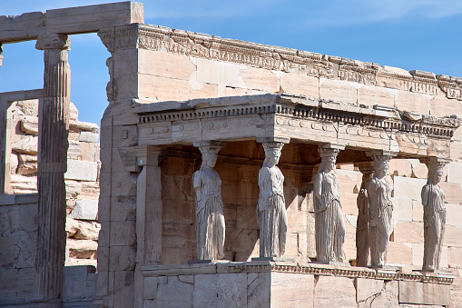 The porch of the Caryatids in the Erechtheion temple on the Acropolis, Athens, Greece. Six columns sculpted as figures of maidens instead of ordinary columns