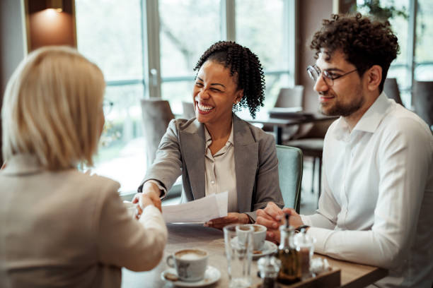 istock Colleagues shaking hands during coffee break at restaurant 2148751393