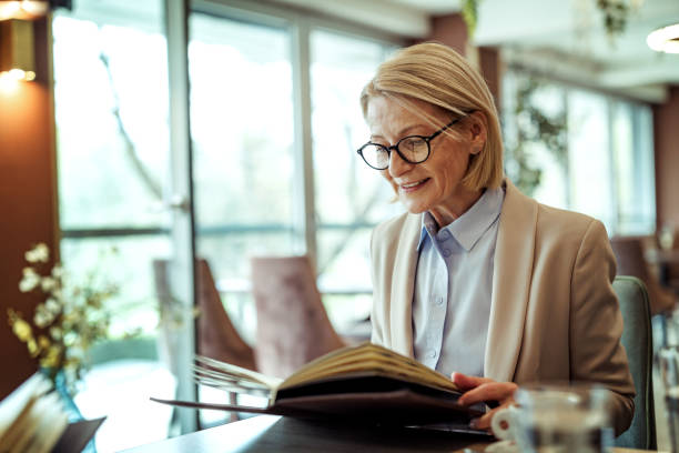 istock Mature businesswoman reading menu at the restaurant 2148751448