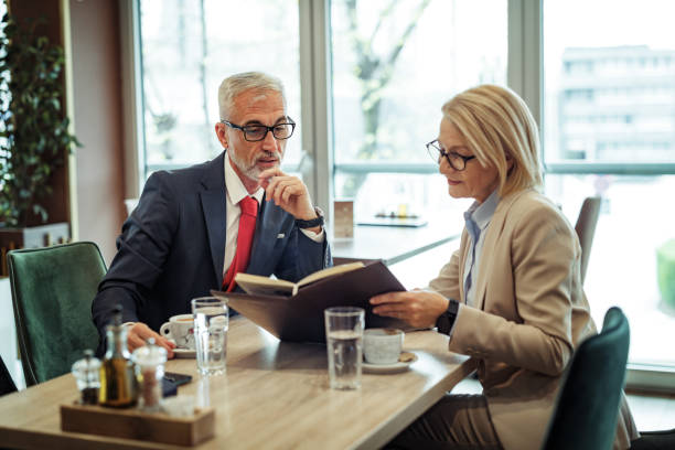 istock Two mature business people reading restaurant menu 2148751452