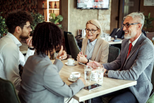istock Coworkers talking during coffee break at the restaurant 2148751573