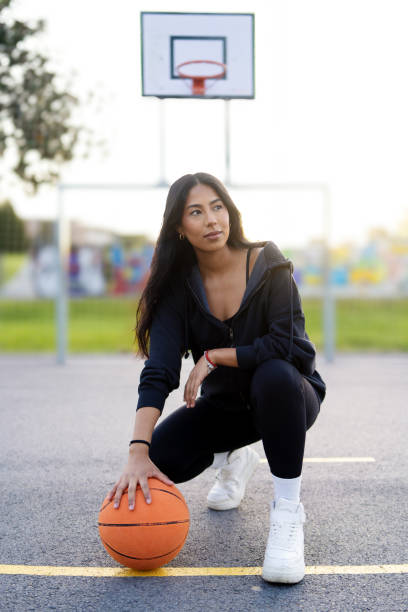 istock Latin woman posing crouching with a basketball ball 2148751799