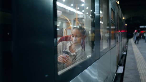 istock Sad girl scrolling smartphone in modern high-speed train view through window. 2148751838