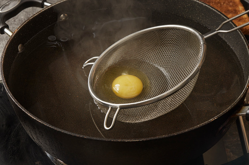 Preparing the Viral Egg Poached in a Strainer