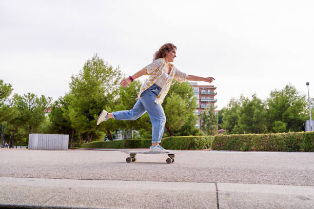 istock woman riding skateboard in rush concept. break the rules. Active young lady riding skateboard in city 2148752351