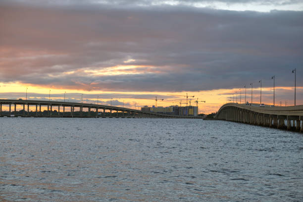 Barron Collier Bridge and Gilchrist Bridge in Florida with moving traffic. Transportation infrastructure in Charlotte County connecting Punta Gorda and Port Charlotte over Peace River.