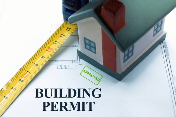 istock Buildings Permit concept with residential building project against an imaginary floor plans and elevations project of a new building 2148752759