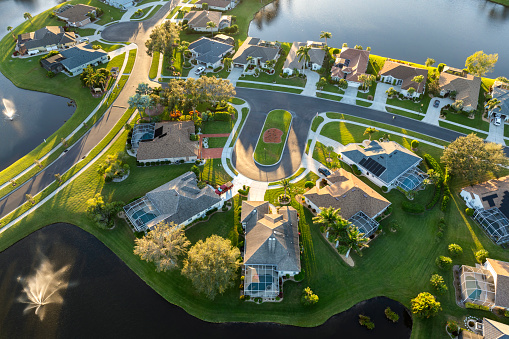 Residential homes at sunset in suburban sprawl development in North Port, Florida. Low-density private houses in rural suburbs. Housing market in the USA.