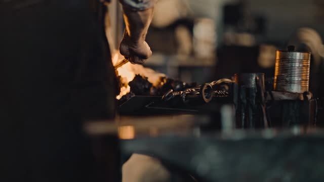 Hammering metal billet on anvil in forge, closeup view, blacksmith is working, 4K, Prores stock video