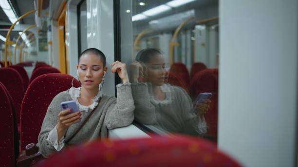 istock Train passenger looking smartphone sitting empty wagon. Woman listening music 2148753789