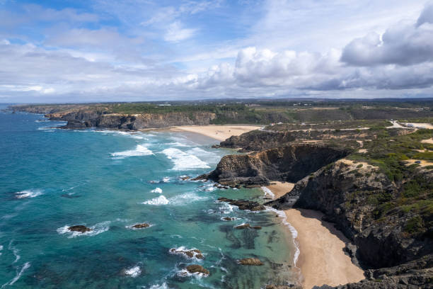 istock Drone view of Praia de Odeceixe beaches from the south - waves and underwater rocks and blue ocean water - cumulus clouds 2148754111
