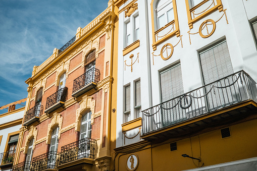 A street in Seville with typical colourful buildings. Historic district in Seville, Spain.