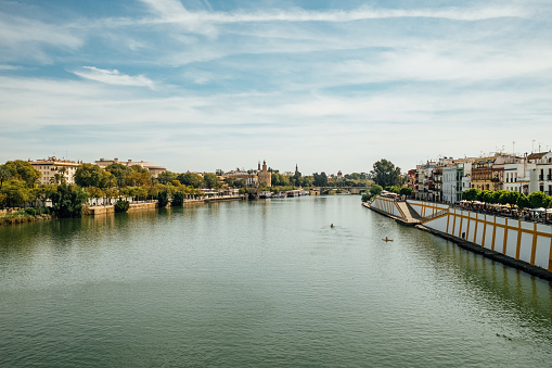 Guadalquivir river with Torre del Oro in the distance. Famous landmark in Seville, Spain.