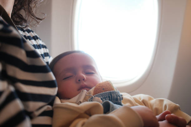 istock A little boy is sleeping during a flight with his mother 2148756255
