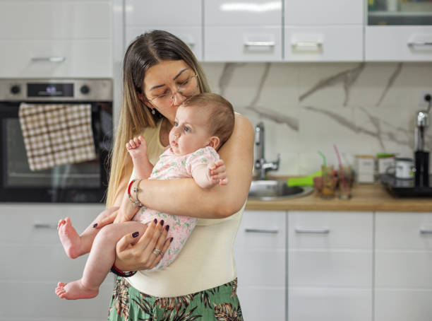 istock Mother playing with her baby in the kitchen 2148757128