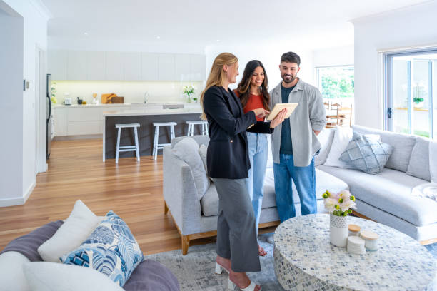 istock Real estate agent or architect showing a couple a new home. 2148757314