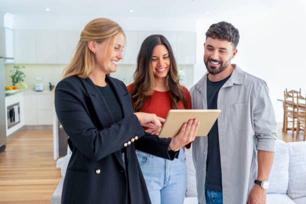 istock Real estate agent or architect showing a couple a new home. 2148757430