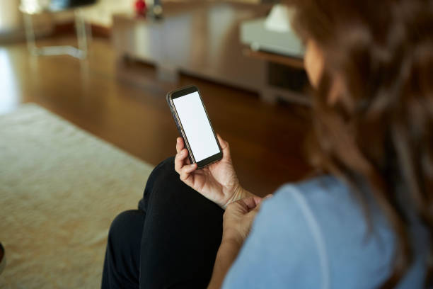 istock a long haired lady holding mobile phone at hand 2148757867