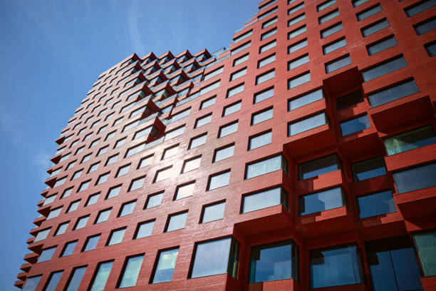 istock Part of a multi-story abstract red office building from below 2148758342