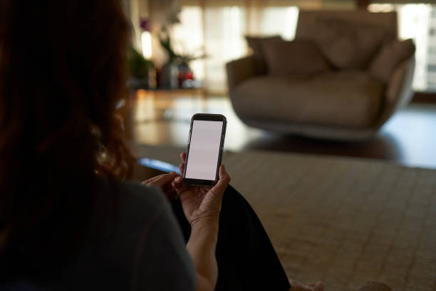 istock a long haired lady holding mobile phone at hand 2148758351