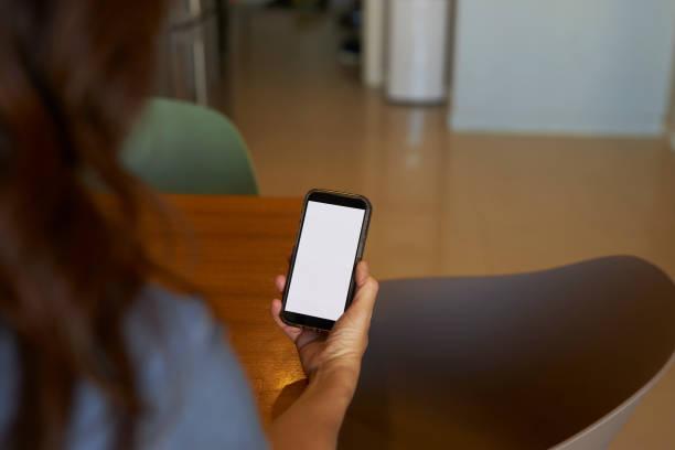 istock a long haired lady holding mobile phone at hand 2148758397