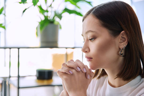 istock Excited sad upset young woman with folded hands, face in profile close-up 2148758456