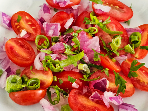 Small tomatoes with red onion and parsley