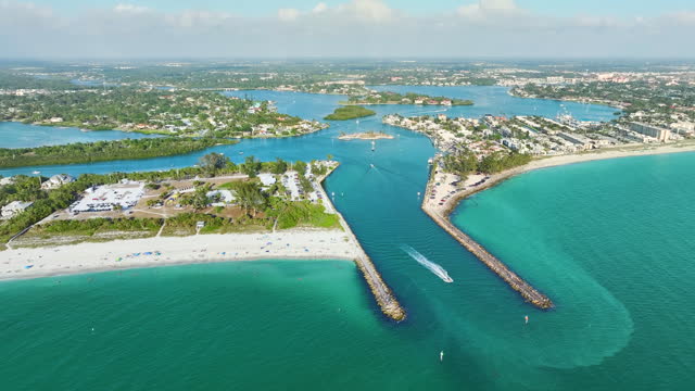 Aerial seascape with Venice South and Nokomis North Jetty in Sarasota County, USA. Many tourists enjoying summer vacation time swimming in warm Mexico gulf water and sunbathing on hot Florida sun
