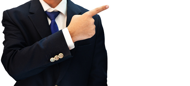 Man in blue suiting pointing towards his right side on isolated white background .