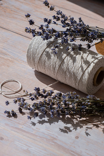 Dried lavender flowers on cotton rope. Esthetic aesthetic composition with copy space for wallpaper, black, template. Minimal eco style still life concept