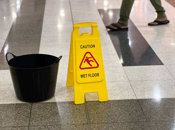 istock Person passing by a caution wet floor sign 2148763461