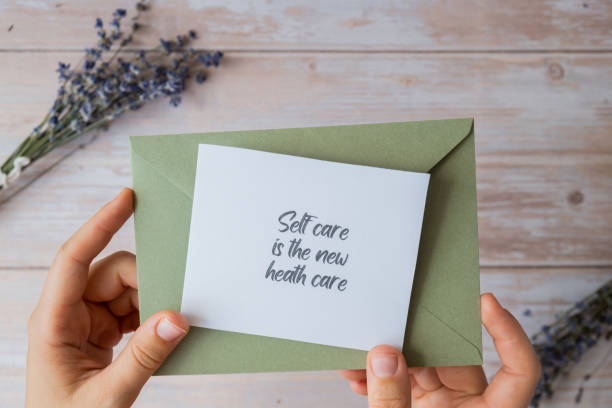 istock SELF CARE IS THE NEW HEALTH CARE text on supportive message paper note reminder from green envelope. Flat lay composition dry lavender flowers. Concept of inner happiness, slowing-down digital detox personal fulfillment 2148763535