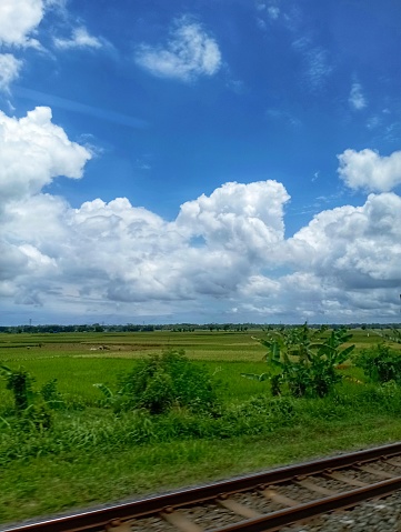 photo of train tracks with blue sky background