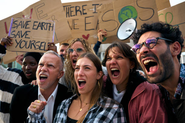 istock Group diverse people shouting angrily outdoor manifesting for global warming together in community. 2148765341
