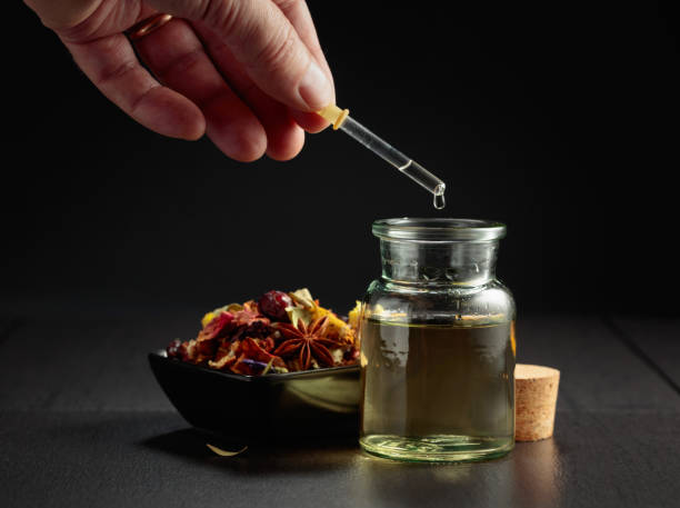istock Dropping essential oil or herbal tincture into a small bottle. 2148770908