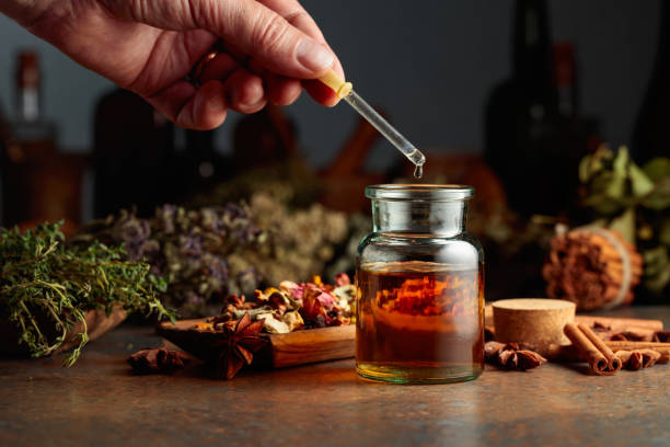 istock Dropping essential herbal tincture into a small glass bottle. 2148770919