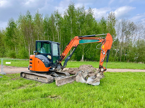 Mini crawler excavator for laying utilities on construction sites.