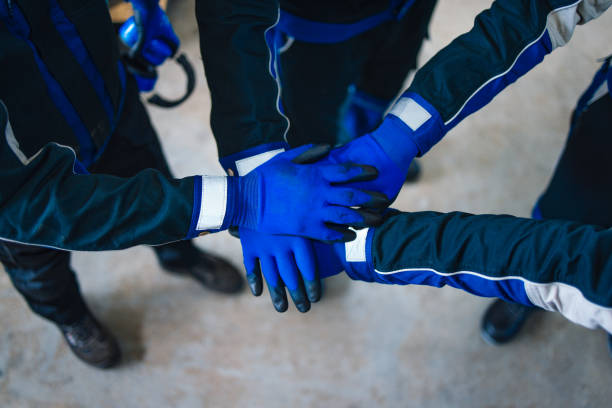 Team of Warehouse Workers Showing Unity with Hand Stack