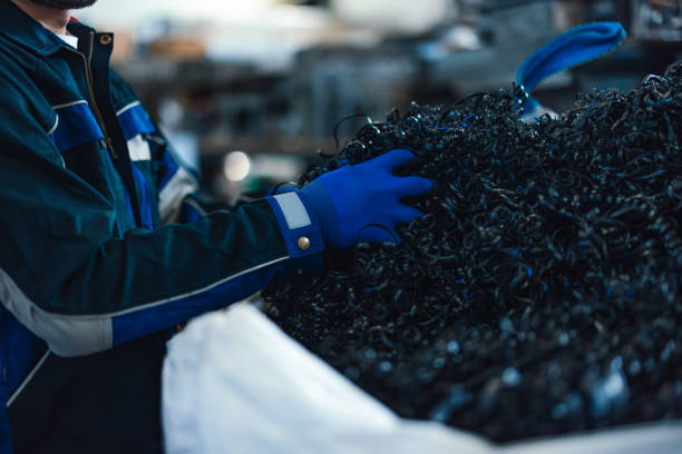 Metal shavings. Production waste. Steel chips after drilling. Garbage in workshop. Spirals of thin metal shavings.