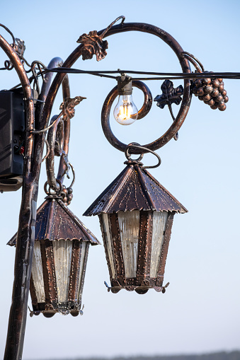 vintage street lamps on a blue sky background